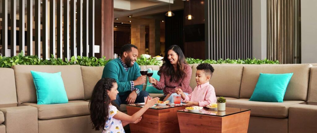 Family dining together at Embassy Suites by Hilton Orlando Sunset Walk